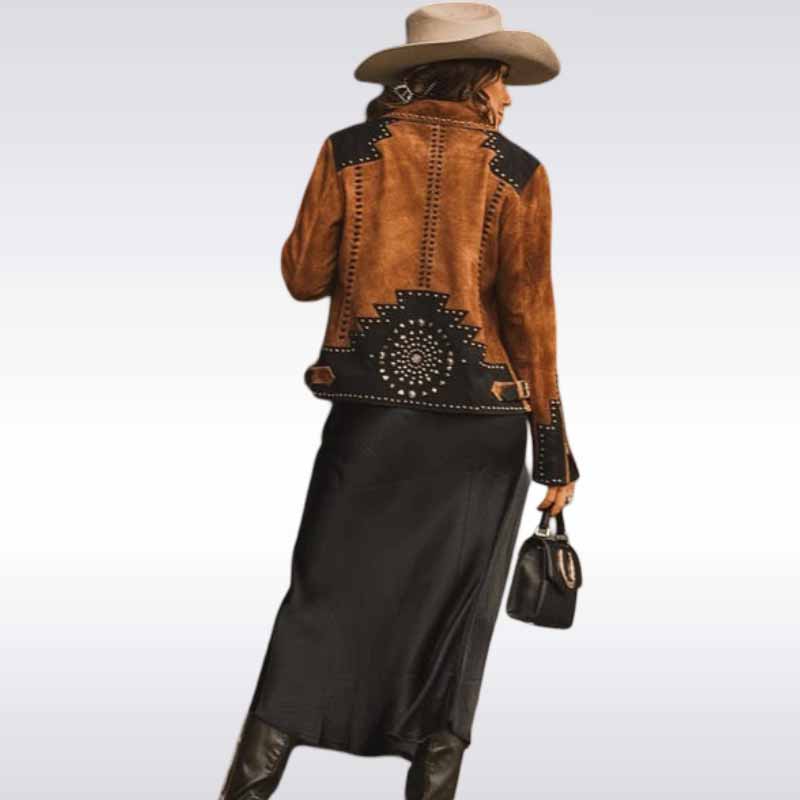 brown leather jacket with studded details, black skirt, and cowboy hat