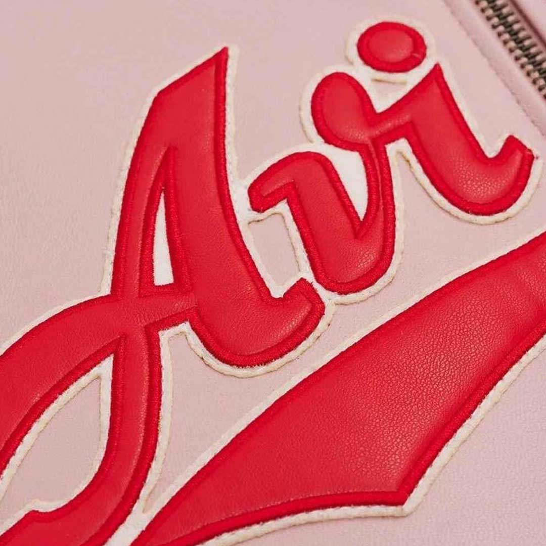 Close up embroidered patches on Avirex pink bomber jacket by Jackets Kingdom
