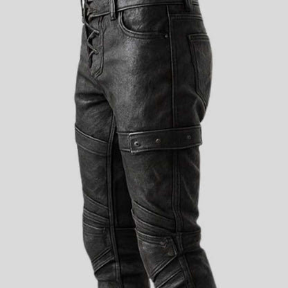 Gothic steampunk warrior pants in black leather with antique metal eyelets and straps