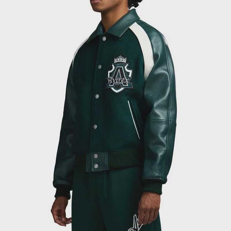 Vintage style green varsity jacket with dark green leather sleeves and snap button closure