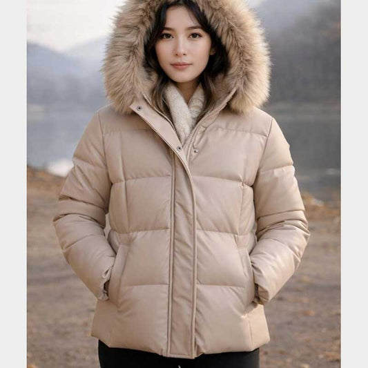 Women's beige leather puffer jacket with luxurious faux fur trimmed hood and padded insulation