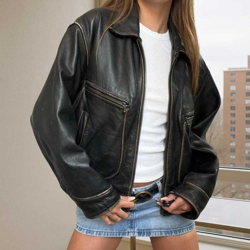 Women's vintage black sheepskin leather bomber jacket with oversized 90s style silhouette