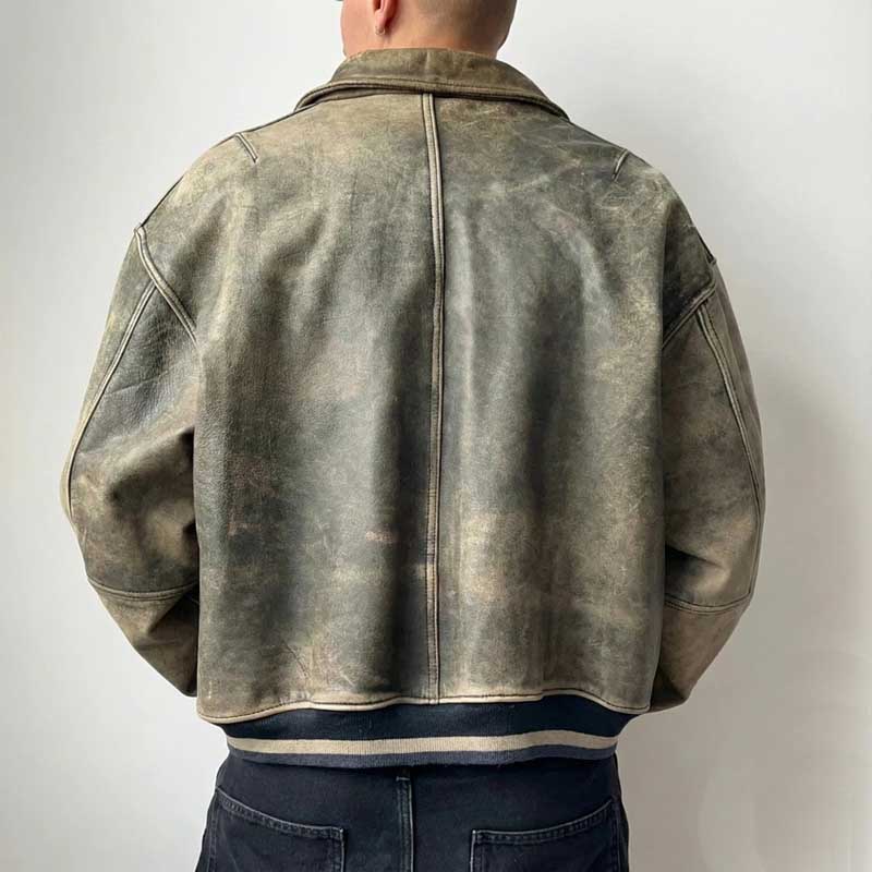 Durable leather bomber in muted olive green featuring worn-in look and snap-button closure